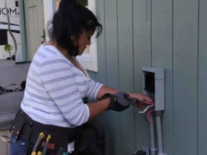Licensed electrician wiring an exterior subpanel in Carlyle