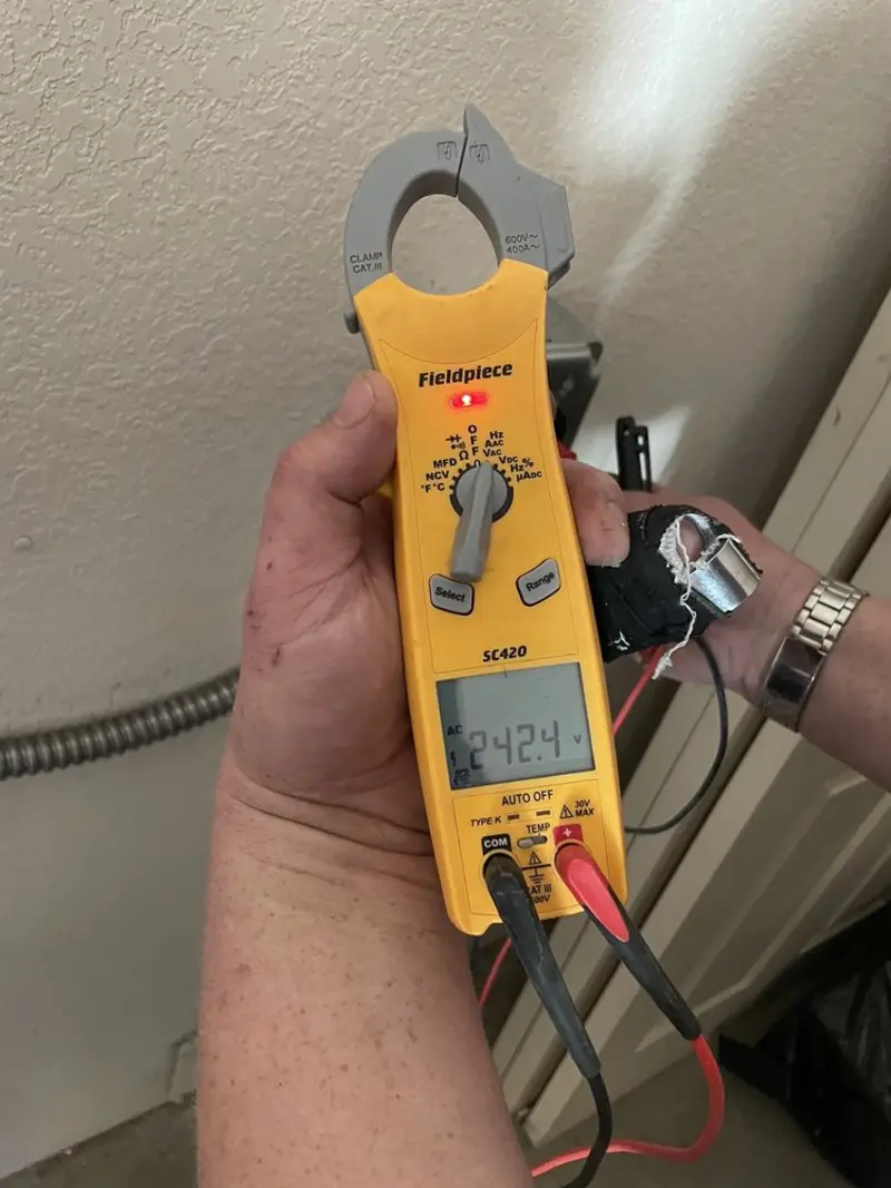 Voltage testing with clamp meter during Outlet Installation in Carlyle